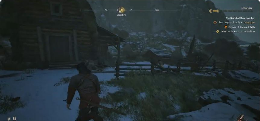 Approach the wooden house across the snowy yard. The outlined doorway is a landmark; the enemies and manual pickup are outside.