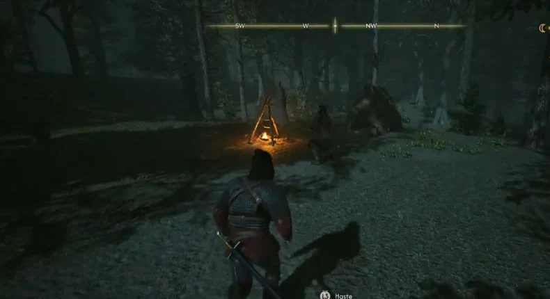 Approach Ursul beside the cooking fire and small tent in the forest clearing.